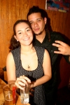 Young Hispanic couple posing in bar.