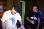 DJ wearing The New Mastersounds t-shirt as onlooker wears black Prince controversy t-shirt